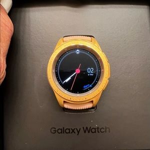 Samsung watch, charger, and extra watch bands.
